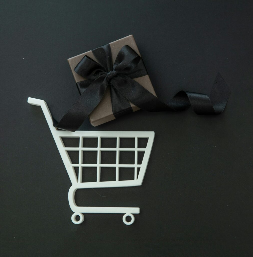 Gift box in a Shopping Cart. Black Friday Sale. E commerce, online shop